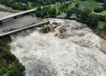 at least two are killed by flooding in the midwest of the us, and a railroad bridge collapses.