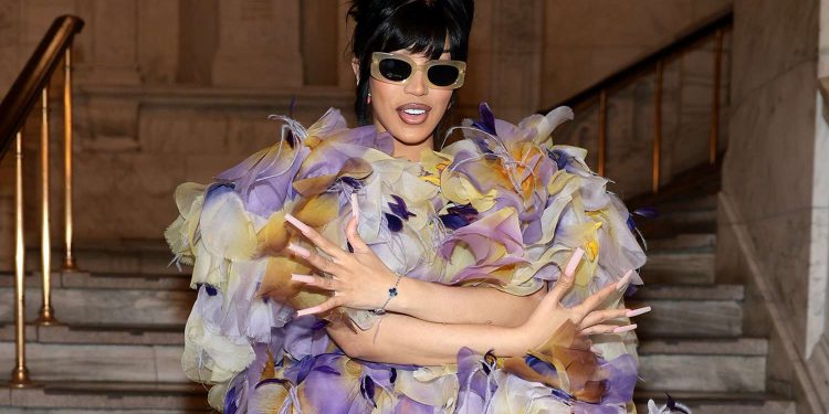 Cardi B sparks pregnancy rumors by wearing an enormous dress and arriving to the Marc Jacobs fashion presentation in style.